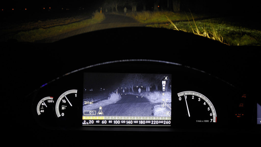 Night vision feature in car shows the road ahead on a dark night.