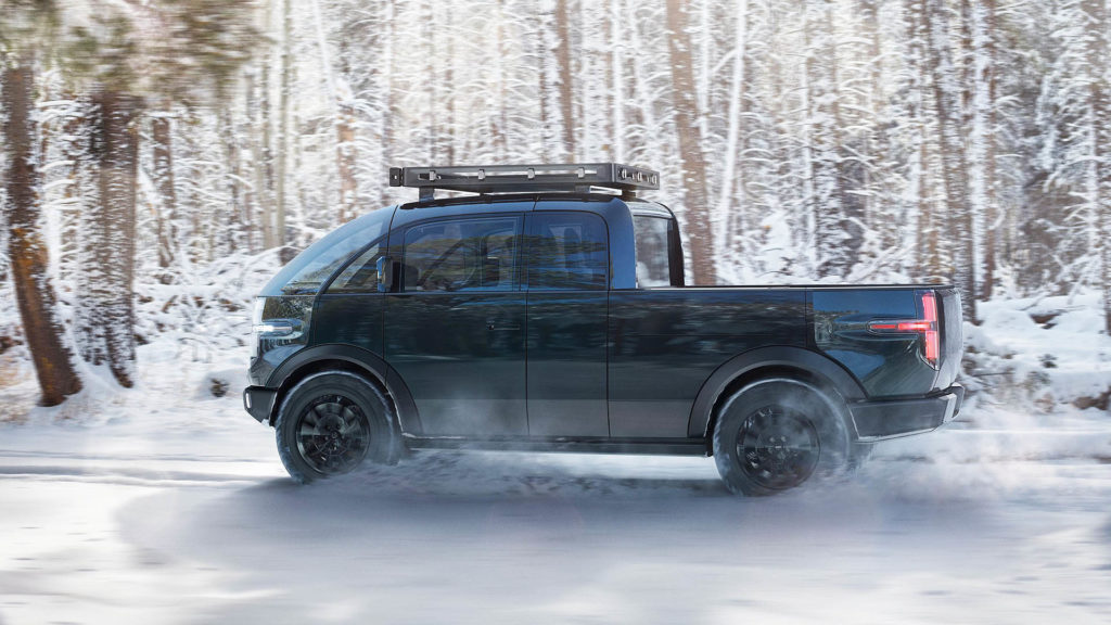 Canoo electric pickup driving off-road.