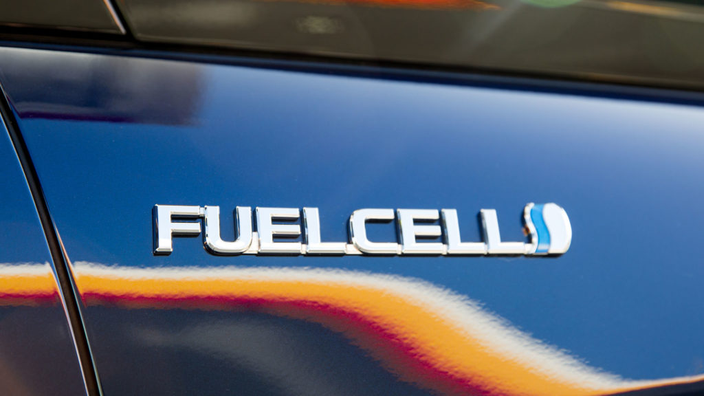 Hydrogen fuel cell emblem on vehicle.
